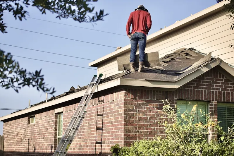 Professional roofer working on a residential roof in Fish Creek